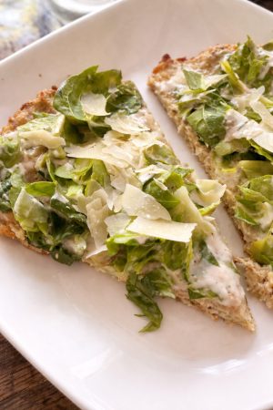 Chicken crust Caesar pizza slices