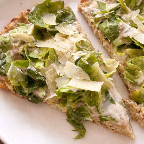Chicken crust Caesar pizza slices