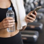 Gym break with water and smartphone